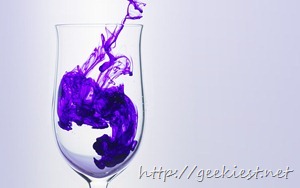Ink drop into water in glass