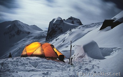 Illuminated tent of winter camp in the mountains